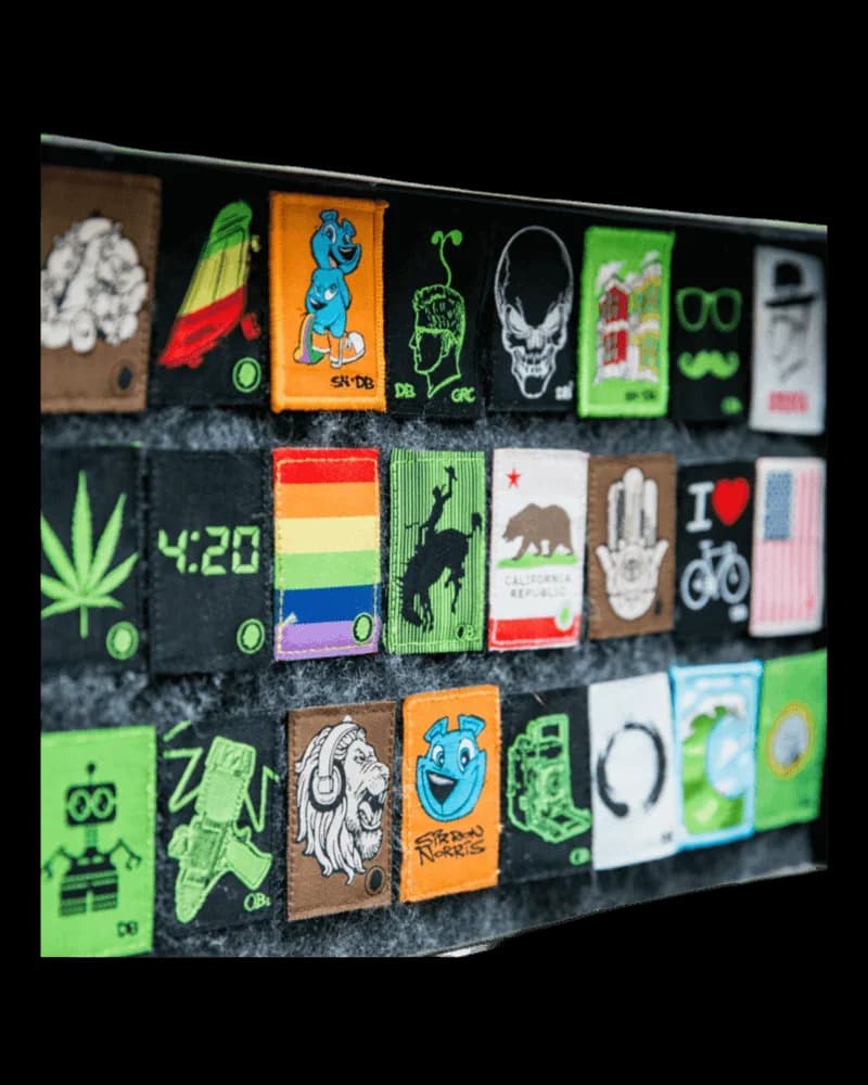 Dime Bags Velcro Patch collection display featuring colorful cannabis-themed patches including leaf, skull, rainbow, bear, and graphic designs on black backing