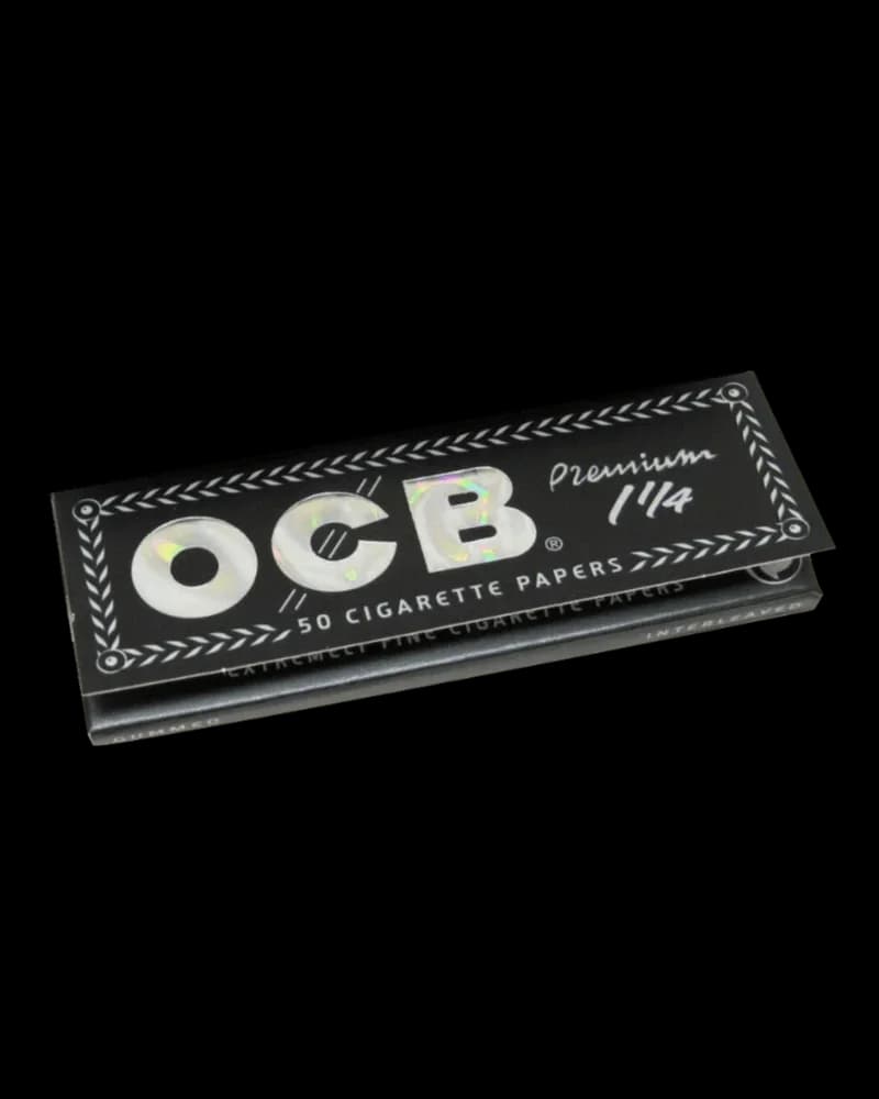 OCB Premium 1 1/4 rolling papers, 50-pack box with black packaging and decorative leaf border design