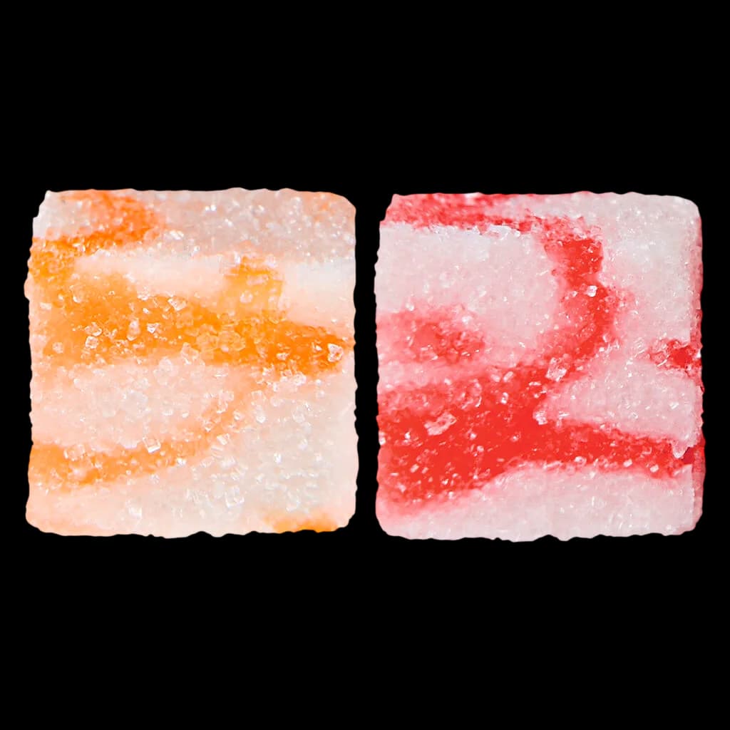Glenn's Strawberry Cream True Hybrid Rosin soft chews, two square gummies with orange and red layered coloring and crystalline sugar coating