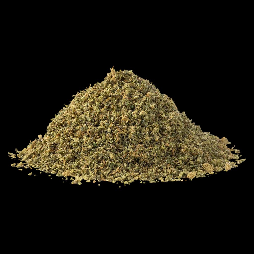 SHRED Sour Ranger 30+ cannabis dried flower pile, showing finely ground texture with golden-green coloration