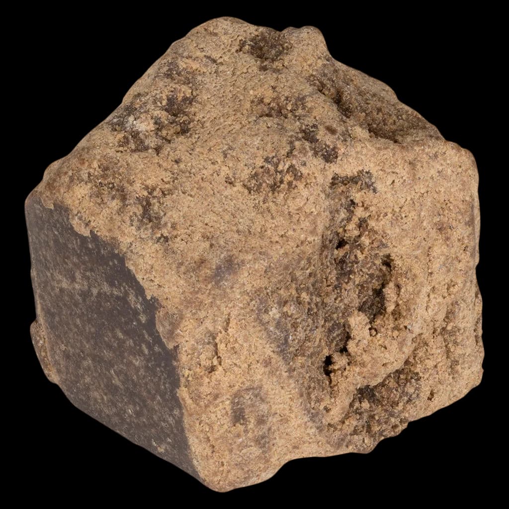 3Saints solventless pressed hash, tan-brown crystalline concentrate on white background