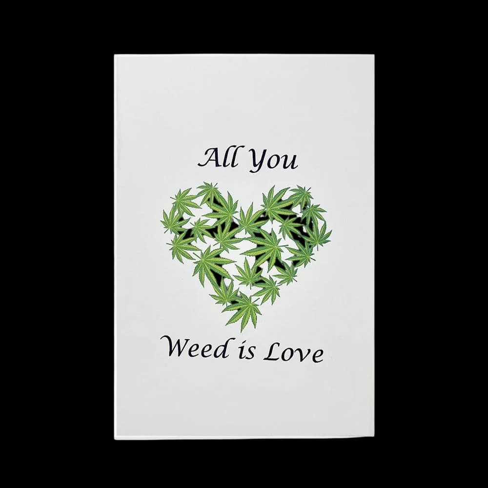 Greeting card with text 'All You' and 'Weed is Love' surrounding a heart shape made of green cannabis leaves