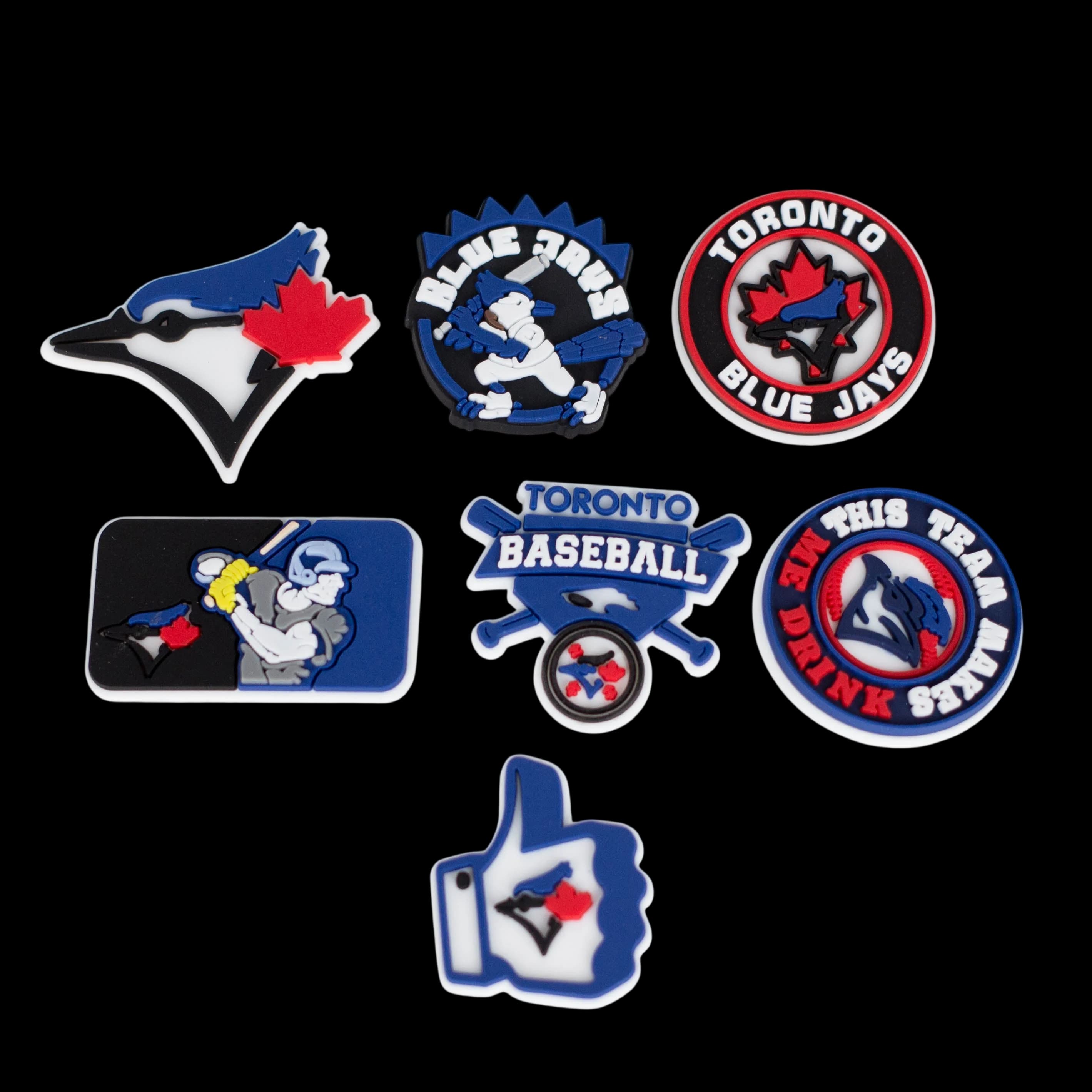 Set of seven Toronto Blue Jays baseball-themed rubber charms featuring team logo, player, and text designs in blue, red, white, and black