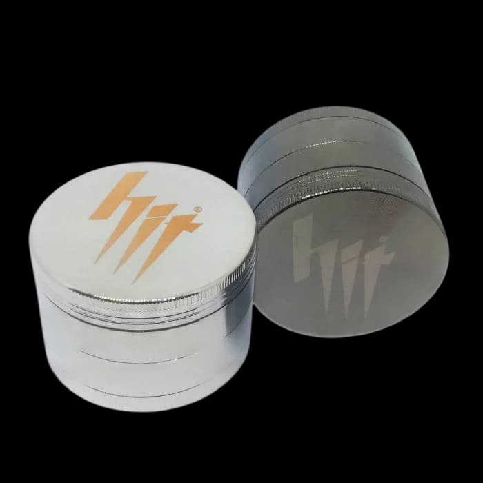 HIT 63mm 4-part metal grinder with white and gray aluminum construction and lightning bolt logo