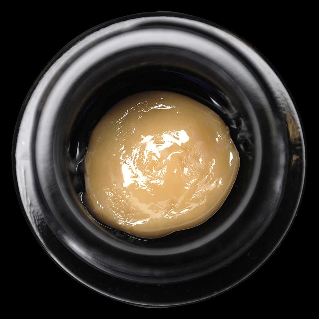 1Above 73u Live Rosin cannabis concentrate in black glass jar, overhead view