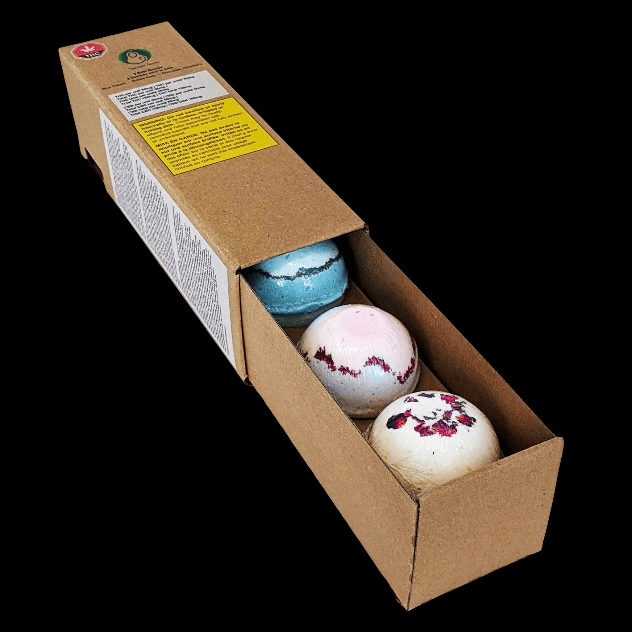 Rebound by Stewart Farms bath bomb set containing three spheres: blue, pink with burgundy swirl, and cream with floral pattern in kraft box