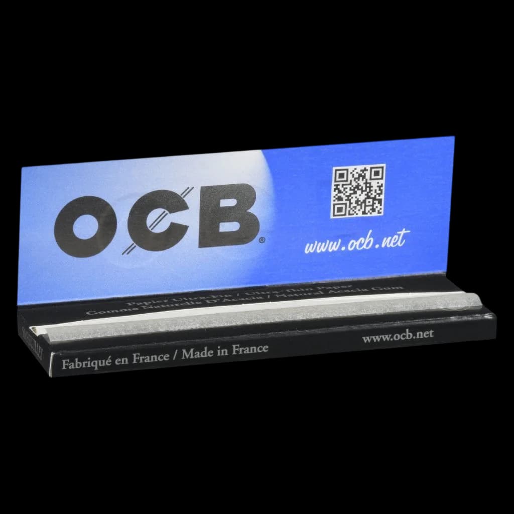 OCB 1 1/4 rolling paper booklet, blue cover with black base, ultra-thin papers partly visible, made in France