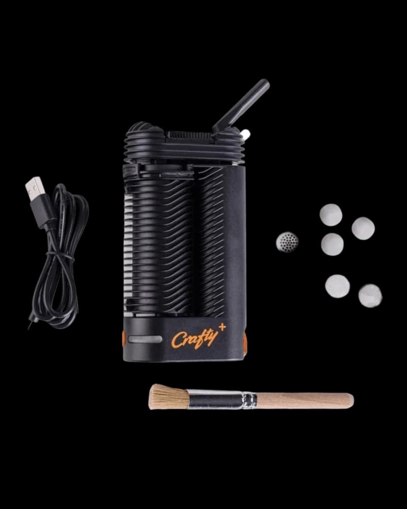 Storz & Bickel Crafty+ vaporizer with USB charging cable, mesh screens, and cleaning brush