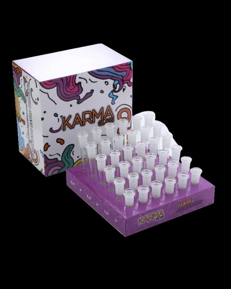 Karma cannabis glass pre-roll tubes display box with purple base tray holding 30 clear glass tubes, colorful illustrated packaging box visible behind