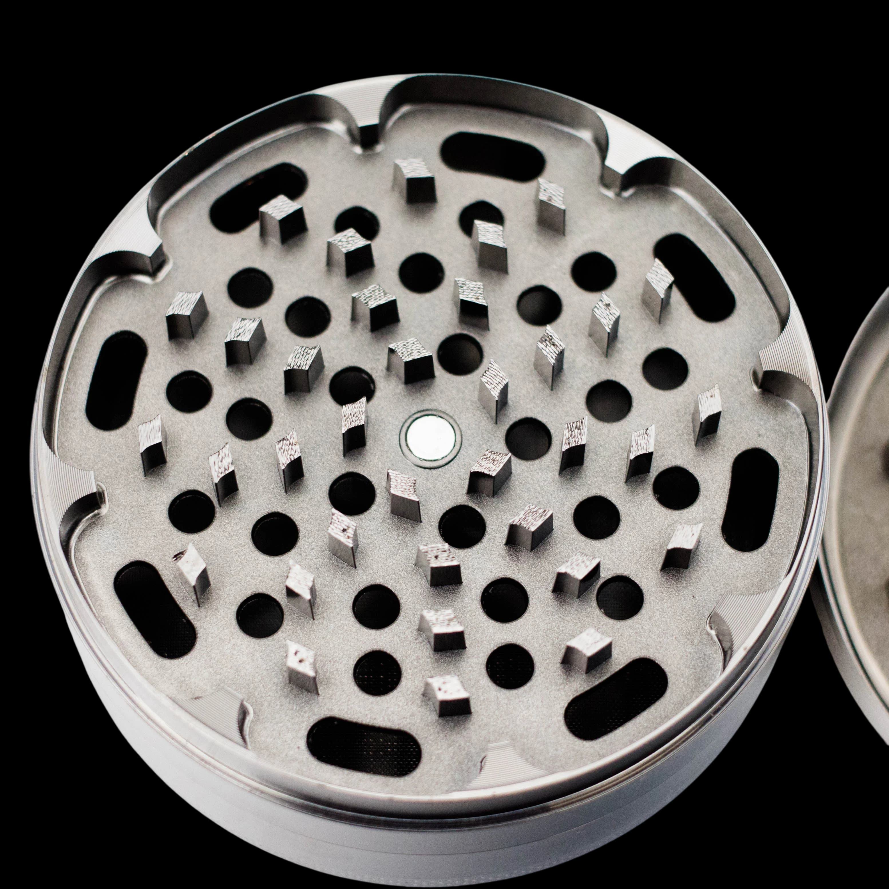 Zinc Gun Metal HIT 4-piece grinder, 100mm, top chamber view showing grinding teeth and kief screen