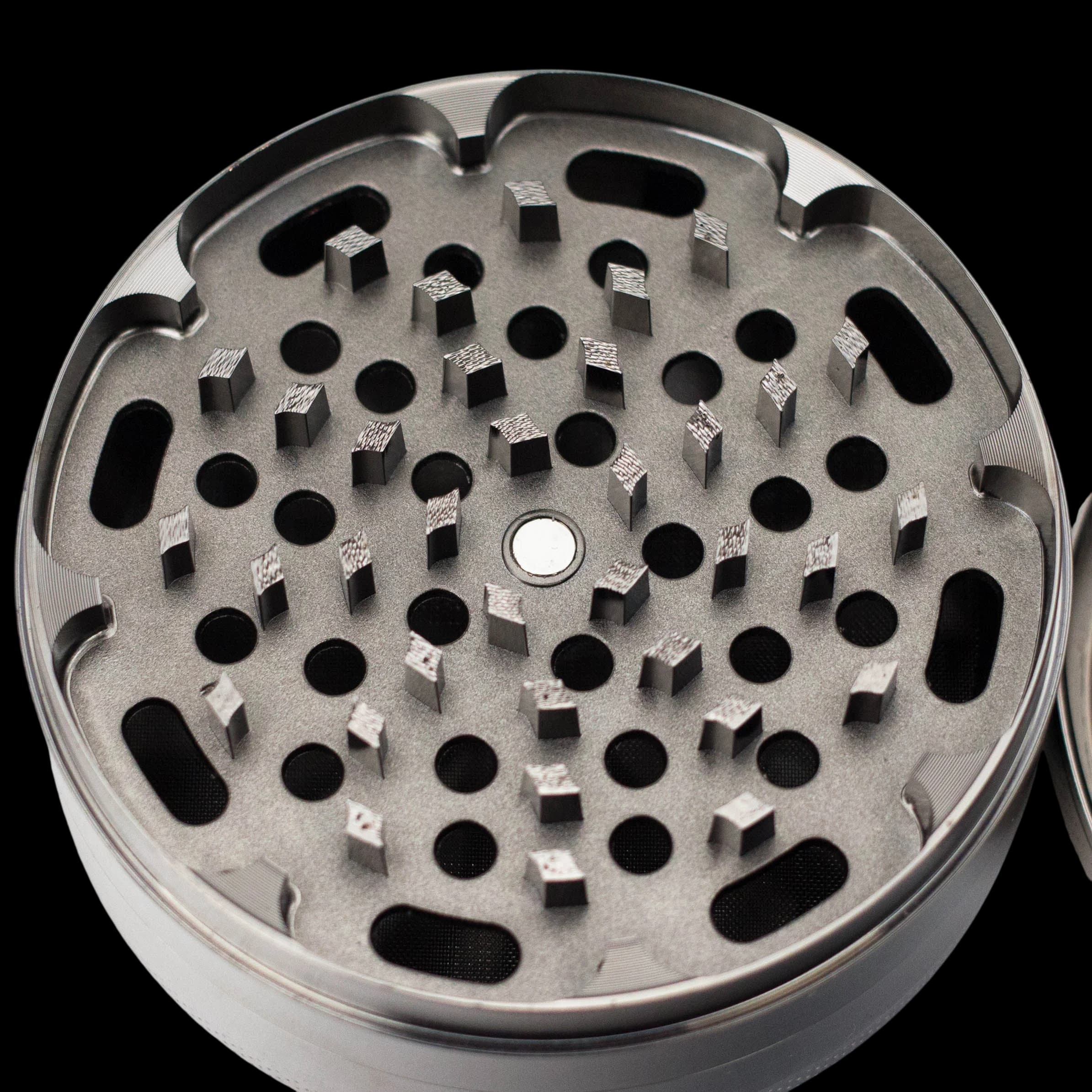 NIBO HIT 100mm 4-piece zinc grinder with gun metal finish, open showing grinding chamber with teeth and kief screen