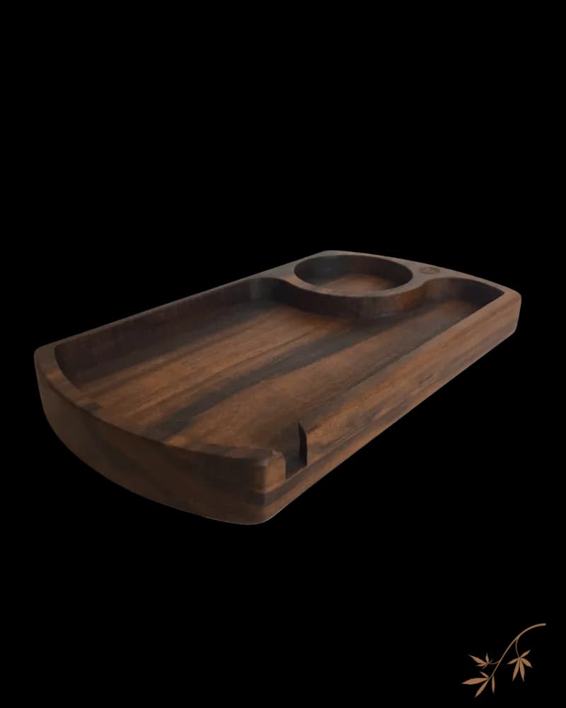 Wooden rolling tray with dark finish, featuring two circular indentations and storage compartments for cannabis accessories